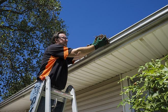 a worker conducting maintenance on a gutter in Lansdowne
